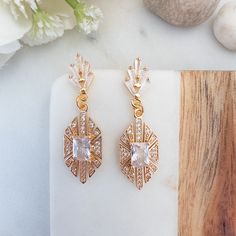 "Embrace the retro charm with our Vintage Style Bridal Earrings, featuring gold art deco designs and dazzling crystal dangles for a touch of old-world glamour. These geometric earrings are perfect for special occasions like a Gatsby gala or your retro wedding event, adding a unique and vintage flair to your ensemble. DETAILS : ------------- - glass crystal with gold plated bezel - gold plated earrings DIMENSION: ---------------- Earrings :  3/8 inch wide x 1.4 inch long ✨For other Art Deco jewel Retro Brass Jewelry With Matching Earrings, Retro Gold Nickel-free Jewelry, Retro Nickel-free Gold Jewelry, Art Deco Dangle Earrings For Anniversary, Retro Brass Dangle Jewelry, Retro Brass Drop Earrings, Retro Dangle Jewelry For Formal Occasions, Art Deco Gold Dangle Bridal Earrings, Gold Art Deco Dangle Bridal Earrings