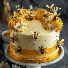 a cake decorated with bees and flowers on a plate