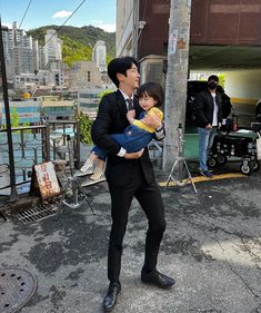 a man in a suit holding a small child