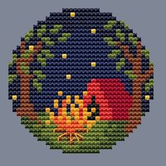 a cross stitch pattern with an image of a campfire in the middle of it