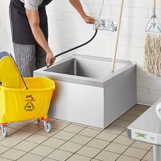 a man is cleaning the floor with a mop and bucket