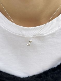 Editor's NotesInvisible collage presents a cute double-heart pendant necklace. It adds a lovely touch to your overall appearance. - Double-heart pendants- Box chain- Smooth glossy surface- Sleek silhouette- Made of silver 925- Lovely and casual mood Measurements(in.)One Size- Size: 15.35 ~ 16.54 in. (L) Composition & Care- Material: Sterling Silver, Cubic- Plated products may discolor over time due to their nature.- Please be careful that discoloration may proceed fa Affordable Silver Double Heart Necklace, Luxury Dainty Double Heart Necklace, Minimalist Heart Necklace, Cheap Silver Charm Necklace For Women, Affordable Classic Silver Charm Necklaces, Pretty Dainty Necklaces, Cheap White Hypoallergenic Charm Necklaces, Delicate Pendant Necklace, Necklaces From Boyfriend