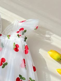 Frolic through the day in this delightful cherry-embellished flower girl dress. The airy tulle skirt is sprinkled with a cheerful pattern of red fruit and greenery, invoking the playful spirit of a sunny orchard. With its flutter sleeves and an oversized back bow, this dress is perfect for a little one who loves to play dress-up for real-life special occasions. US Length Bust size 9-12M 18.5 20.1 1-2Y 19.3 20.9 3-4Y 20.5 22.1 4-5Y 21.7 23.2 5-6Y 22.9 24.0 Summer Floral Print Tulle Dresses, White Sleeveless Sweet Princess Dress, Sweet White Sleeveless Princess Dress, Cute Tulle Dress For Spring, Sweet Summer Princess Dress For Garden Party, Summer Dress-up Flower Dress, Cute Spring Tulle Skirt Dress, Summer Floral Print Princess Dress For Party, Spring Cute Princess Dress With Tulle Skirt