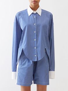 Jonathon Anderson imparts his avant-garde perspective into LOEWE's blue shirt, cut from striped cotton poplin with white tipped cuffs and a curved hem. Indigo Fabric, Cotton Poplin Shirt, Indian Designer, Indian Designer Wear, Tailored Shirts, Poplin Shirt, Cut Shirts, Designer Wear, Blouse Styles