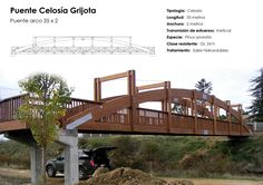 a wooden bridge over a dirt road next to a truck on the side of the road