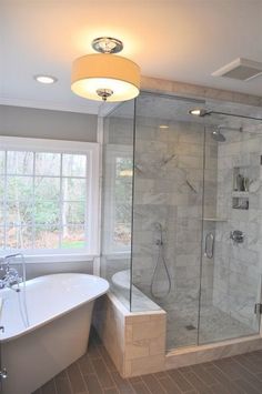 a bathroom with a tub, shower and sink