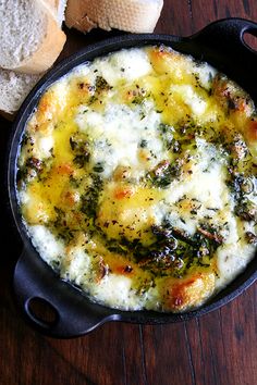 an omelet with cheese and spinach is in a cast iron skillet