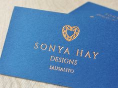 a blue business card with a gold heart on it's front and the words sonya hay designs sausalito