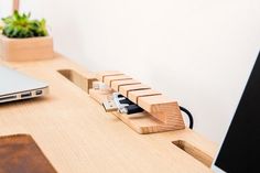 a laptop computer sitting on top of a wooden desk