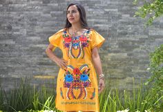 This lovely was handmade in Mexico. The beautiful colorful flowers were embroidered by hand, so each one is unique. You will love wearing this comfortable cotton dress with short sleeves. It is perfect for a hot summer day. This dress comes just above or below the knee, depending on how tall you are. It has a square neckline and cute little puffy sleeves. Inch measure Medium 19 * 35 Large 23 * 37 XL 26 * 37 XXL 27 * 38 About Our Items: Each one of our items is handmade/hand woven by Indigenous c Traditional Yellow Embroidered Summer Dress, Traditional Yellow Embroidered Dress For Summer, Yellow Short Sleeve Festival Dresses, Yellow Tunic Dress With Floral Embroidery, Yellow Bohemian Embroidered Short Sleeve Dress, Yellow Bohemian Short Sleeve Embroidered Dress, Bohemian Yellow Embroidered Dress With Short Sleeves, Huipil Dress, Mexican Embroidered Dress