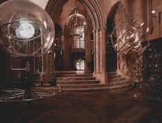 an old photo of the inside of a building with large glass balls in front of it