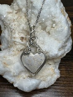 This beautiful detailed fossil coral heart pendant is roughly 2" tall and 1" wide, it comes with a complimentary 18" stainless steel chain, and in a gift box, ready for gifting!  These are not costume pieces that will chip away or rust over time. They will last forever if taken care of, which is why I include a free polishing cloth with every order.  All of my pieces are made with high quality wire from Rio Grande. Quality is very important to me.       If you have any questions, message me, I'm happy to help. Unique Sterling Silver Necklace For Gift, Unique Sterling Silver Necklace As Gift, Artisan Silver Heart Pendant Necklace, Nature-inspired Silver Heart Necklace, Handmade White Stainless Steel Jewelry, Unique Heart Charm Jewelry Gift, Nickel-free Heart-shaped Jewelry As Gift For Mom, Heart-shaped Nickel-free Jewelry For Mom, Nickel-free Heart-shaped Jewelry Gift For Mom