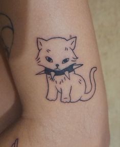 a cat with a bow tie on it's neck is shown in this tattoo