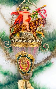 a christmas ornament hanging from the side of a tree with an image of a woman on it