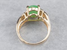 This pretty vintage ring is a rich combination of yellow gold and sweet apple green dyed jade. The metalwork around the stone is simple and subtle, with just a light pattern gracing the simple shoulders! Metal: 14K Yellow Gold Gem: Dyed Jade Gem Measurements: 10.9 x 8.4 mm, Oval Ring Size: 5.75 Marks: "STULLER@14K*" Stamped on the inside band Right Hand Ring, Luxury Jade Rings Fine Jewelry, Demantoid Garnet, Luxury Jade Rings In Fine Jewelry Style, Luxury Elegant Jade Rings, Luxury Jade Ring With Polished Finish, Luxury Polished Jade Rings, Aquamarine Cocktail Ring, Light Pattern