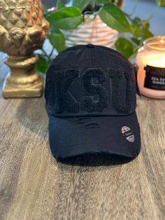 Im loving the black on black monochromatic hat with chenille K S U letters. Kbethos brand distressed hat. adjustable so one size fits most! Distressed Hat, Black On Black, Trucker Cap, Labour Day, Caps Hats, Accessories Hats, Art Collection, Bathing Beauties, Accessory Gift