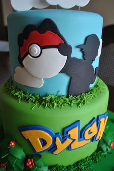 a birthday cake decorated with pokemon characters and grass