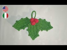 a crocheted christmas ornament with holly leaves