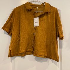 Cropped Button Up Shirt. Lose Fitting And Soft Material. Never Been Worn! The Color Is Called Copper. Orange Collared Tops For Summer, Casual Collared Orange Blouse, Orange Casual Short Sleeve Blouse, Casual Orange Collared Blouse, Casual Short Sleeve Orange Blouse, Orange Short Sleeve Casual Blouse, Casual Orange Short Sleeve Blouse, Orange Summer Shirt With Button Closure, Orange Button-up Tops For Summer