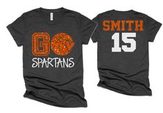 an orange and black shirt with the number 15 on it that says go spartans