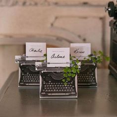 two typewriters with plants growing out of them