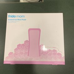 an instruction manual for the frida mom breast pump on a table next to a coffee cup