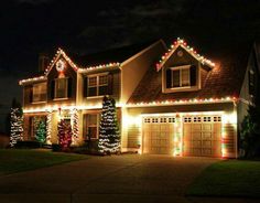 christmas lights on the front of a house with happy new year written in green mark