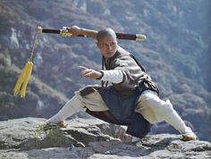 an image of a man doing karate on top of a mountain