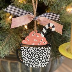 a cupcake ornament hanging from a christmas tree