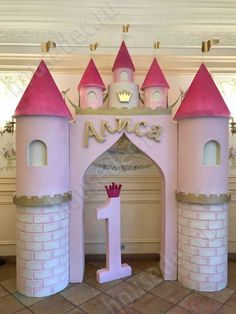 a pink princess castle with the number one on it