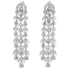 A stunning pair of earrings in a timeless design. 8.34 carats of round brilliant and marquise cut diamonds set in 18k white gold. The diamonds are of the highest quality FG color VS clarity. Approximately 2.25 inches in length. The round diamonds are set into "illusion" pear shapes to give a more unique sparkle. These earrings are a WOW! Dazzling Marquise Diamond Earrings For Formal Events, Luxury Bridal Earrings Marquise With Brilliant Cut, Luxury Bridal Marquise Earrings With Brilliant Cut, Luxury Marquise Diamond Earrings For Formal Occasions, Luxury Marquise Brilliant Cut Bridal Earrings, Luxury Marquise Diamond Earrings For Evening, Luxury Marquise Cut Diamond Earrings, Marquise Brilliant Cut Diamond Earrings For Evening, Formal Diamond Marquise Bridal Earrings