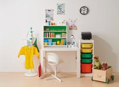 there is a desk and chair in the room with many items on it, including bookshelves