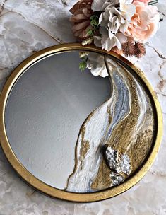 a mirror that has some flowers on it