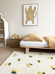 a bed room with a neatly made bed and a painting on the wall