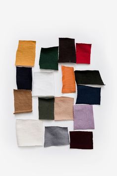 several different colors of cloths laid out on top of each other in the shape of squares