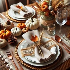 the table is set for thanksgiving dinner with white plates and silverware