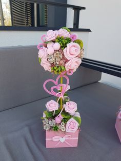 a bouquet of flowers in a pink box on a table