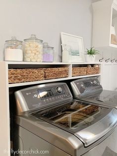 a washer and dryer sitting next to each other in a room with white walls