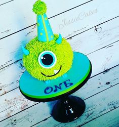 a birthday cake with a green monster hat on it