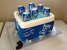 a birthday cake made to look like a cooler with six cans of beer in it