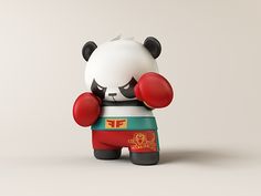 a small toy panda bear with boxing gloves on its head and hands in front of it's face