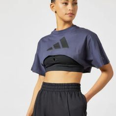 A Cropped-Tee For Post-Yoga Comfort. All Those Planks And Warrior Poses Are Paying Off. Show Off Your Hard-Earned Yoga Abs In This Adidas Crop Top. Pair It With A Favorite Pair Of High-Rise Tights, And Move Through The Day In Total Comfort. Our Cotton Products Support More Sustainable Cotton Farming. Loose Fit Ribbed Crewneck 100% Cotton Single Jersey Sleeve Pocket Cropped Length Single Jersey Supports The Better Cotton Initiative Color: Shadow Navy Do Not Bleach Do Not Tumble Dry Do Not Dry Cle Adidas Cotton Sportswear Tops, Blue T-shirt For Gym, Blue Crew Neck Crop Top For Sports, Adidas Cotton Workout T-shirt, Adidas Moisture-wicking Tops For Workout, Adidas Moisture-wicking Workout Tops, Casual Adidas Tops With Moisture-wicking, Adidas Moisture-wicking Sports Tops, Adidas Athleisure Short Sleeve Activewear