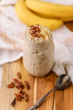 a jar filled with oatmeal sitting on top of a wooden cutting board