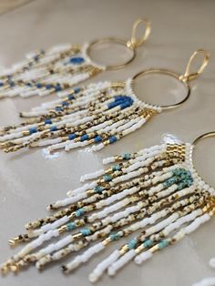 Ocean Blue Beachy Hoop Beaded Earrings Boho Fringe Earrings with Gold, White, Cream & Capri Blue Can choose Medium Blue, Turquoise or Bronze Inspired by the ocean - These are a great, fun pair to wear day or night, adding a sparkly boho, earthy vibe to your outfit  Lightweight, easy to wear all day, with hypoallergenic hooks These make a great gift for a friend, gift for a wife, vacation earrings Materials: Miyuki Delica glass beads - the highest quality, sturdy, lightweight beads in gorgeous shades of white, cream, gold, and capri blue. Hooks are 14k gold-plated leverback hooks, hypoallergenic, 14k gold-plated hoops Can upgrade to gold-fill french earwires * Length: About 4 inches long, but very lightweight Production: Made in Ecuador and ships in 1-4 weeks in US How to care for jewelry: Gold Beaded Hoop Earrings For The Beach, Summer Tiny Beads Small Hoop Earrings, Summer Tiny Beaded Small Hoop Earrings, Blue Beaded Small Hoop Jewelry, Summer Dangle Hoop Earrings With Tiny Beads, Blue Hoop Earrings With Ear Wire For Beach, Blue Hoop Jewelry For The Beach, Gold Hoop Earrings With Colorful Beads For Beach, Handmade Blue Beaded Hoop Earrings