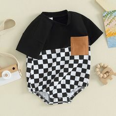 Your little critter will be the most dapper on the block in this OLIVER Checkered Short-Sleeve Onesie! Perfect for summer, this onesie is perfect for your little man no matter what his summer adventure holds! Available in two colors, he's sure to look as handsome as he is handsomely comfortable! Playful Black Short Sleeve Onesie, Black Cotton Onesie For Spring, Family Matching Black Cotton Onesie, Spring Cotton Black Onesie, Black Short Sleeve Onesie For Summer, Spring Black Cotton Onesie, Black Playful Bodysuit For Casual Wear, Black Cotton Onesie For Summer, Black Short Sleeve Onesie For Family Matching