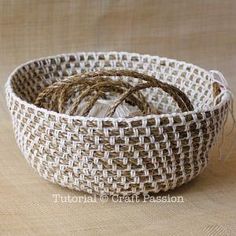 a woven basket with twine in it on a beige tableclothed cloth background