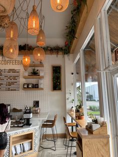 the interior of a coffee shop with hanging lights