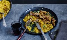 two plates of food with meat and rice on them, one has a fork in it