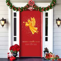 a red door with a christmas card on it and decorations around the front entrance area