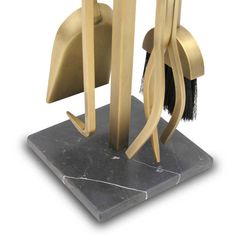 an art deco sculpture on a marble base with gold and black accents, including a brush